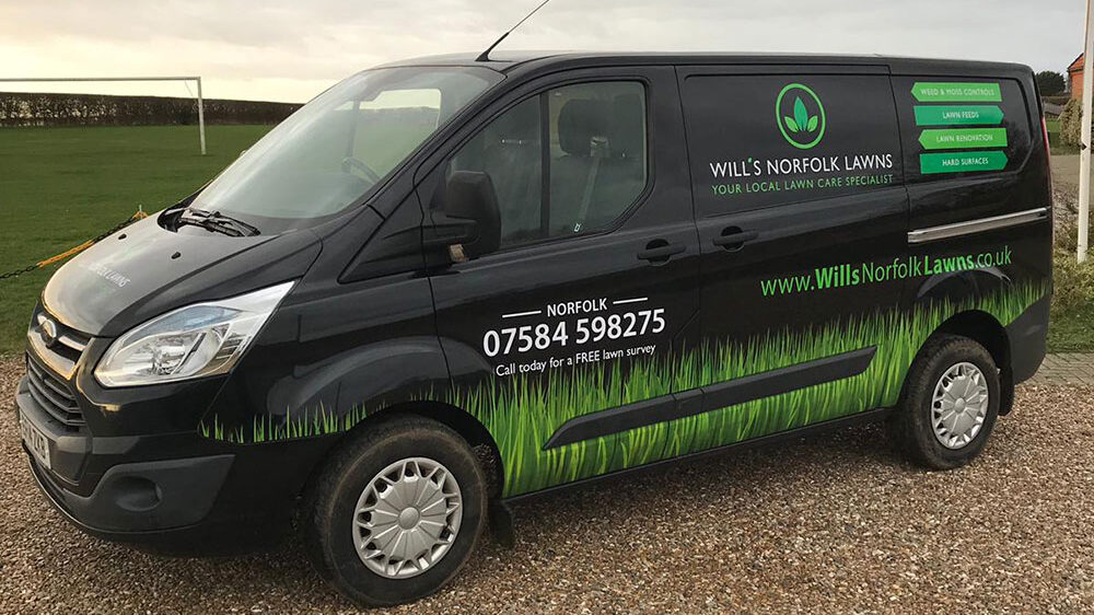 Black Ford Transit Custom with wrap and printed graphics
